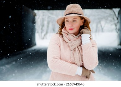 Woman Aged 40+ In Knitted Coat And Hat. In Winter, A Woman Stands In The Wind.