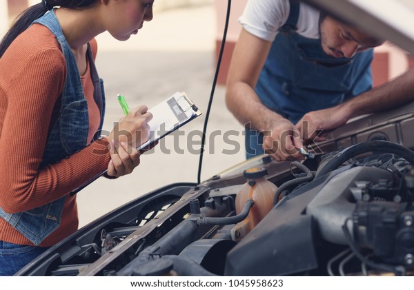 Woman agent filling insurance form\
insurance. Agent inspecting damaged car after accident with\
insurance claim form on  clipboard,Accident and insurance\
concept.