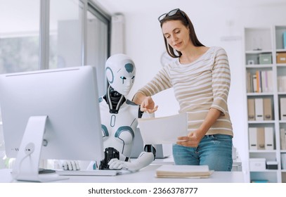 Woman and AI robot working together in the office, automation and technology concept