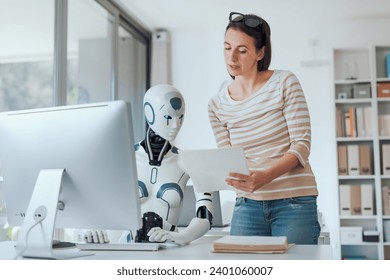 Woman and AI robot working together in the office, automation and technology concept - Powered by Shutterstock