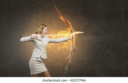 Woman aiming her goal . Mixed media - Powered by Shutterstock