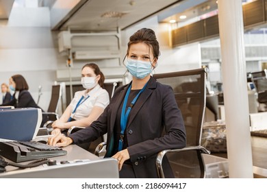 Woman Airline Employee Wearing Face Mask While Working At Airline Check In Counter In Airport