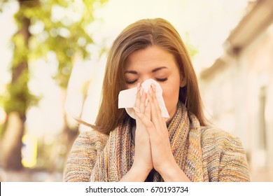 Woman With Allergy Symptoms Blowing Nose