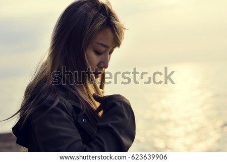 Woman alone on the sunrise beach