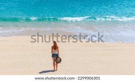 woman alone on tropical beach- vacation, travel, freedon concept