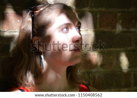 Similar – Hopeful Portrait of a Young Woman at the Window