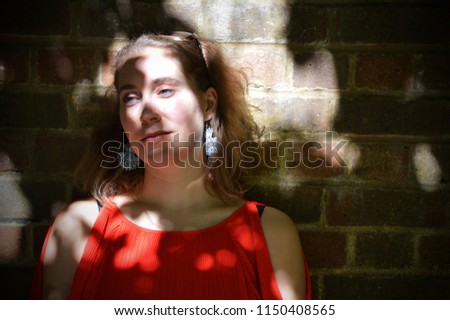 Similar – Hopeful Portrait of a Young Woman at the Window