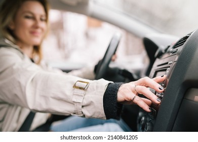 A Woman Amateur Driver Is Playing The Radio In The Car Before Start Driving. Traveling With Music And Having Fun In The Car.