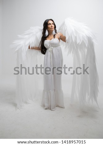 woman with angel wings in studio with white backgound