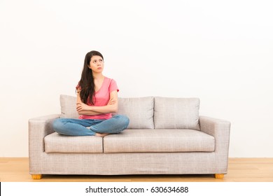 Woman Angrily Unhappy Thinking About Family Bad Matters Sitting On Living Room Sofa In Wood Flooring With White Background.