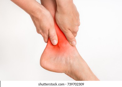 Woman With Ankle Pain Holding Her Aching Leg - Body Pain Concept