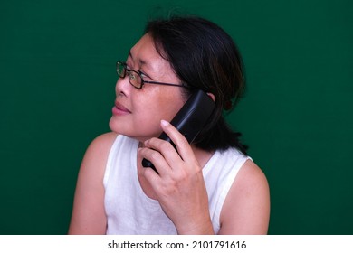 A Woman Answering A Call On A Cordless Phone