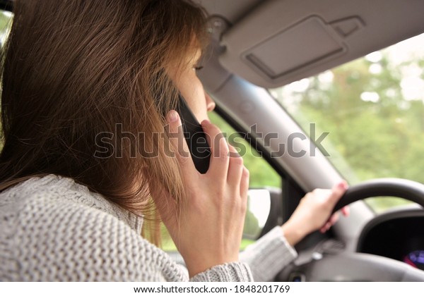 The woman answers the
phone while driving. Driver creates danger by talking on the phone
while driving