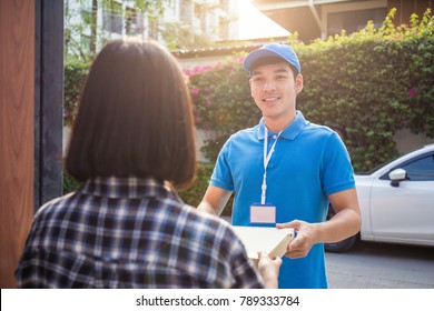 Woman appending receive sign signature after accepting a delivery of boxes from delivery man, sign and receive delivery concept