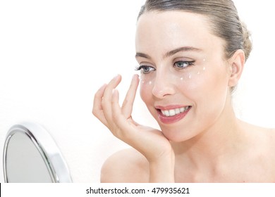 The Woman Applies Eye Contour Cream