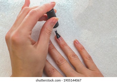 A Woman Applies A Primer To Her Nails Before Applying Varnish. Close-up Of A Hand.