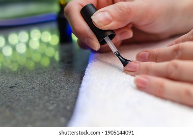 A Woman Applies A Primer To Her Nails Before Applying Varnish. Close-up Of A Hand.