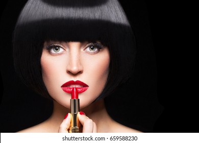 Woman Apply Red Lipstick Isolated On Black