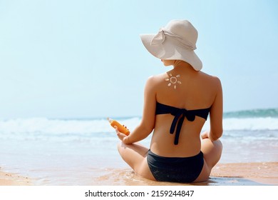 Woman apply sun cream protection cream on her  tanned Shoulder. Beautiful Girl on a beach.Sun Protection.Sun Cream. Skin and Body Care.Portrait Of Female Holding Moisturizing Sunblock. - Shutterstock ID 2159244847