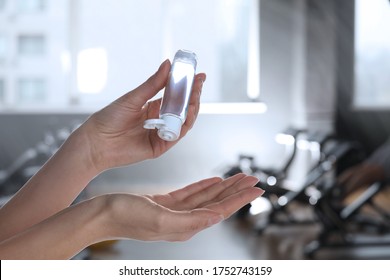 Woman applying antiseptic gel at gym, closeup. Preventive measures during epidemic period  - Powered by Shutterstock