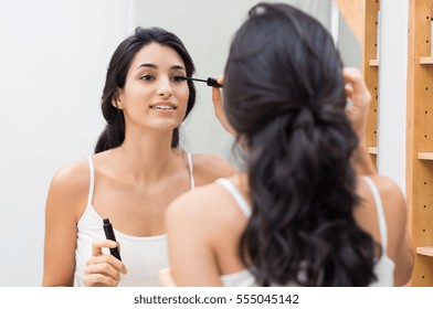 Woman Applying Black Mascara On Eyelashes With Makeup Brush. Young Beautiful Woman Applying Mascara Makeup On Eyes At Bathroom. Beautiful Brunette Girl Applying Makeup On Eyes In The Morning Time.