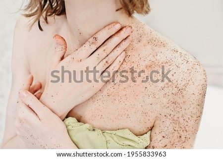 woman applying body exfoliating scrub. natural organic coffee polish on a woman's body 
