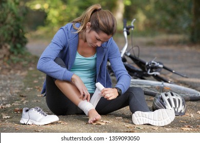 Woman Applying Compression Bandage On Her Head After Injury