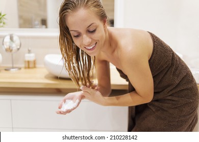 Woman Applying Conditioner After The Shower  