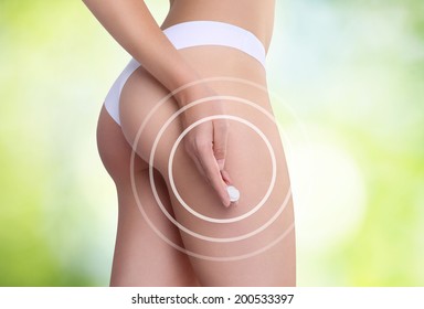 Woman Applying Cosmetic Cream From Cellulite On The Buttocks