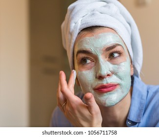 Woman applying cosmetic face mask - Powered by Shutterstock