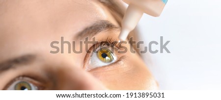 Woman applying eye drop. Vitamin drops from tiredness and redness eyes. Suffering from irritated eye,optical symptoms.