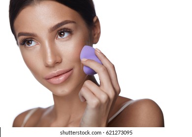 Woman Applying Foundation. Closeup Of Young Female Blending Foundation With Cosmetic Sponge. Portrait Of Beautiful Girl With Soft Fresh Skin Tone Applying Makeup. Beauty Cosmetics. High Resolution