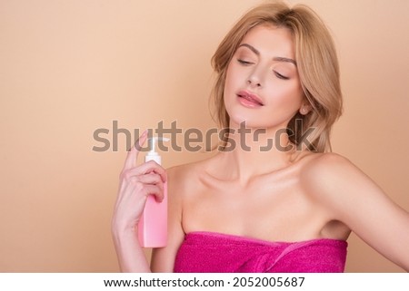 Woman applying hair conditioner. Woman hold bottle shampoo and conditioner. Beauty product.