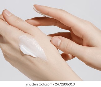 Woman applying hand cream. Copy space. Closeup.  - Powered by Shutterstock