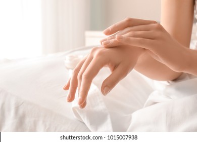 Woman Applying Hand Cream At Home, Closeup