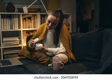 woman applying hand creme , sitting at home - Shutterstock ID 2069358959