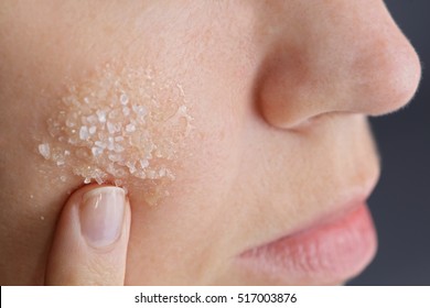 Woman Applying Homemade Facial Scrub From Honey And Sea Salt. Skin Care Concept