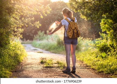 Woman Is Applying Insect Repellent Against Mosquito And Tick On Her Hand During Hike In Nature. Skin Protection Against Insect Bite