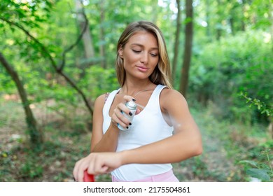 Woman applying insect repellent against mosquito and tick on her arms during hike in nature. Skin protection against insect bite
