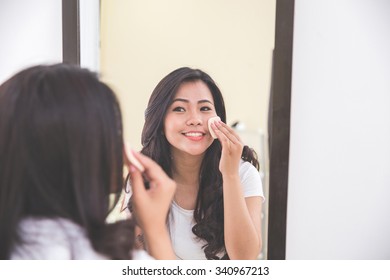 Woman Applying Make Up Into Her Face, Putting On Face Powder