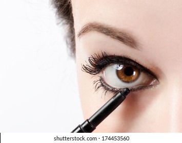 Woman Applying Make-up With Eye Pencil