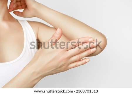 woman applying moisturizer on elbow skin, care for dry elbow skin