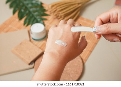 Woman Applying Moisturizing Cream Treatment Test Cosmetic On Hands.Beauty And Make-up Concept