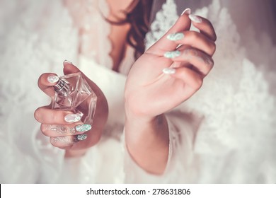 woman applying perfume on her wrist