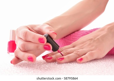 Woman Applying Pink Nail Polish