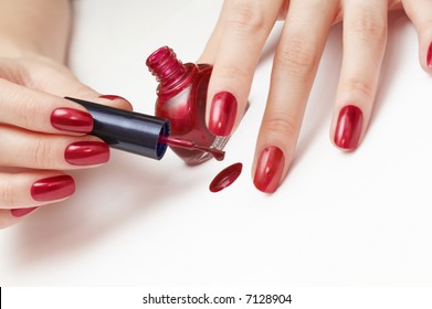 Woman Applying Red Nail Polish