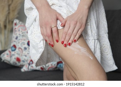 Woman Applying Skincare Product On Her Legs At Home. Domestic Life, Home Spa, Skin Care And Pampering Concept.