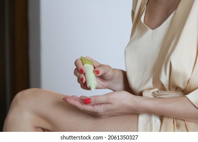 Woman Applying Skincare Product On Her Legs At Home. Domestic Life, Home Spa, Skin Care And Pampering Concept.	