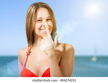 Woman Applying Sun Screen On Her Nose