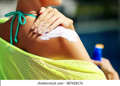 Woman Applying Sunblock Protection On Shoulders